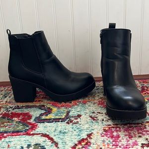 Black high heel boots. The brand is Moda Chics